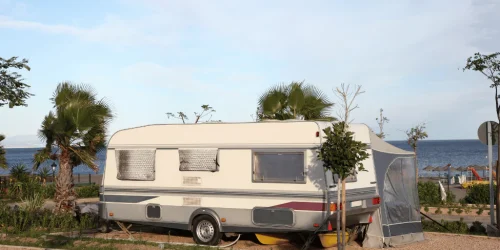 Caravan parked by the seaside on sunny day.